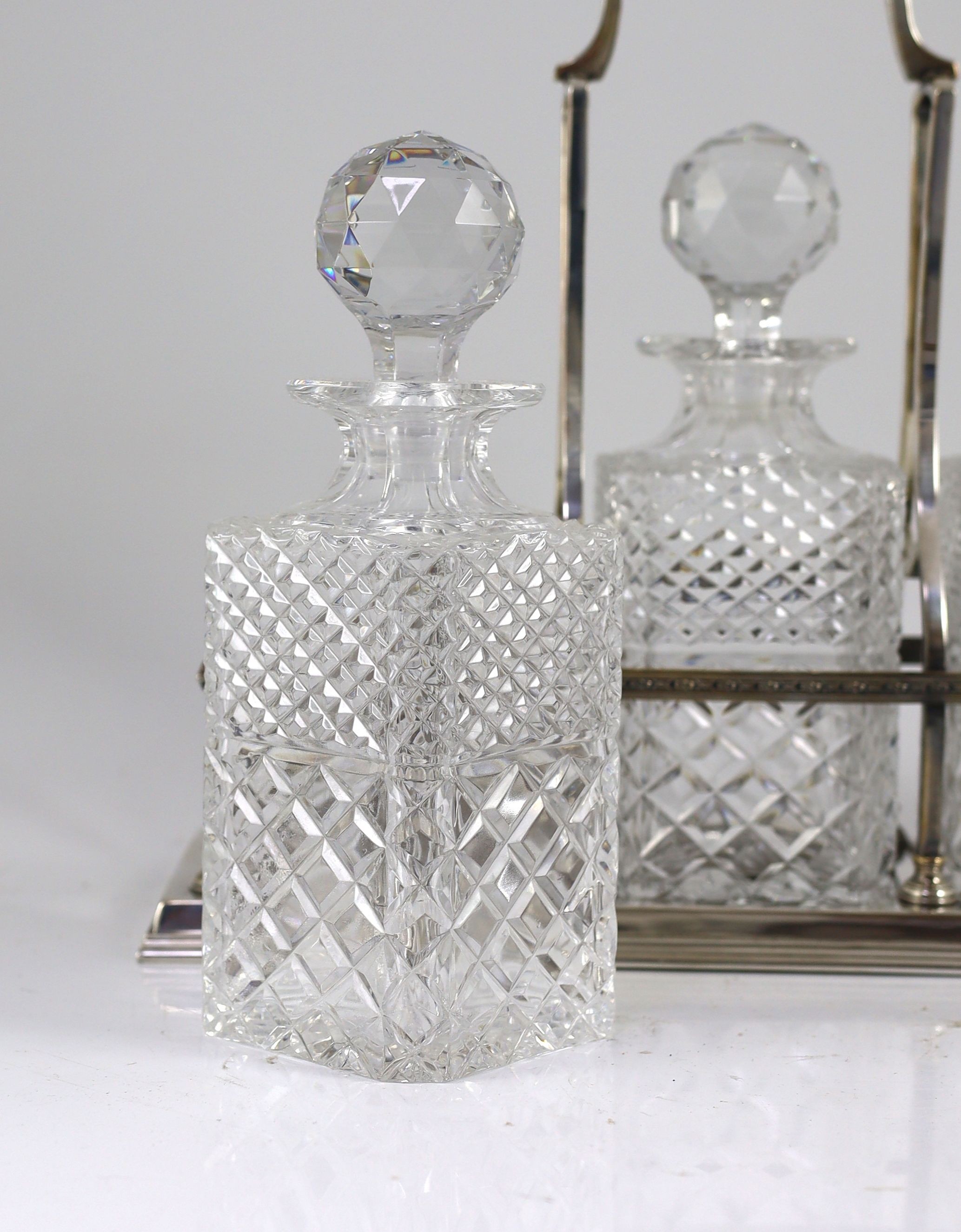 A modern silver three bottle rectangular decanter stand, by C.J. Vander Ltd